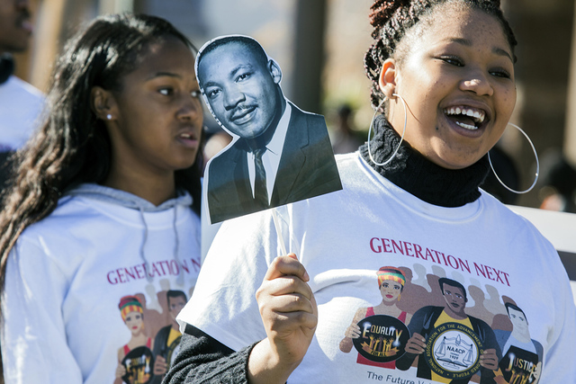 I'yanne Davis holds a sign showing the image of Martin Luther King Jr. during the 35th annual Dr. Martin Luther King Jr. Parade in downtown Las Vegas on Jan. 16, 2017. Review-Journal file photo