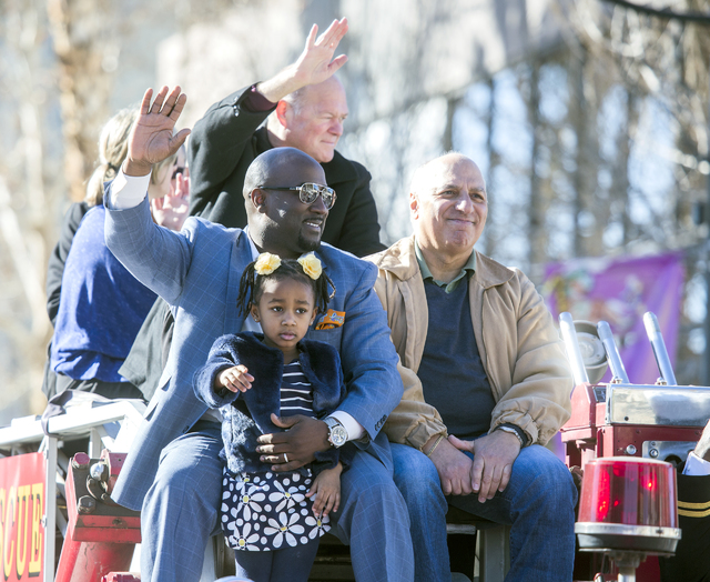 Las Vegas City Councilmen Ricki Barlow, left, Bob Beers and Stavros Anthony ride on top of a fire truck during the 35th annual Dr. Martin Luther King Jr. Parade in downtown Las Vegas on Jan. 16, 2 ...
