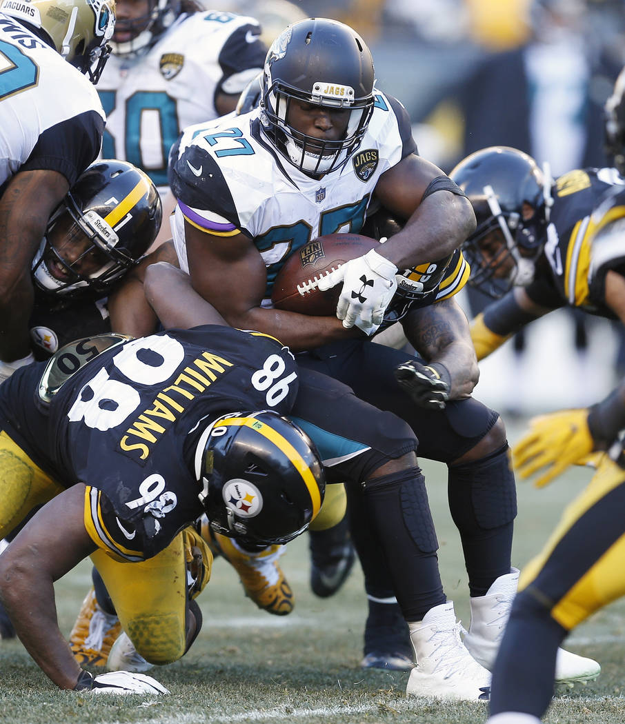 Jacksonville Jaguars running back Leonard Fournette (27) tries to get past Pittsburgh Steelers inside linebacker Vince Williams (98) during the second half of an NFL divisional football AFC playof ...