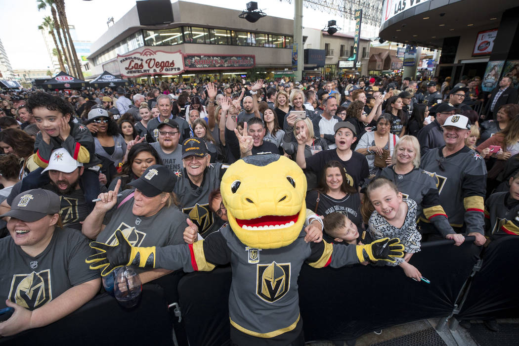 The Vegas Golden Knights mascot Chance the Golden Gila Monster poses with fans during the team's first fan fest at the Fremont Street Experience in downtown Las Vegas on Sunday, Jan. 14, 2018. Ric ...