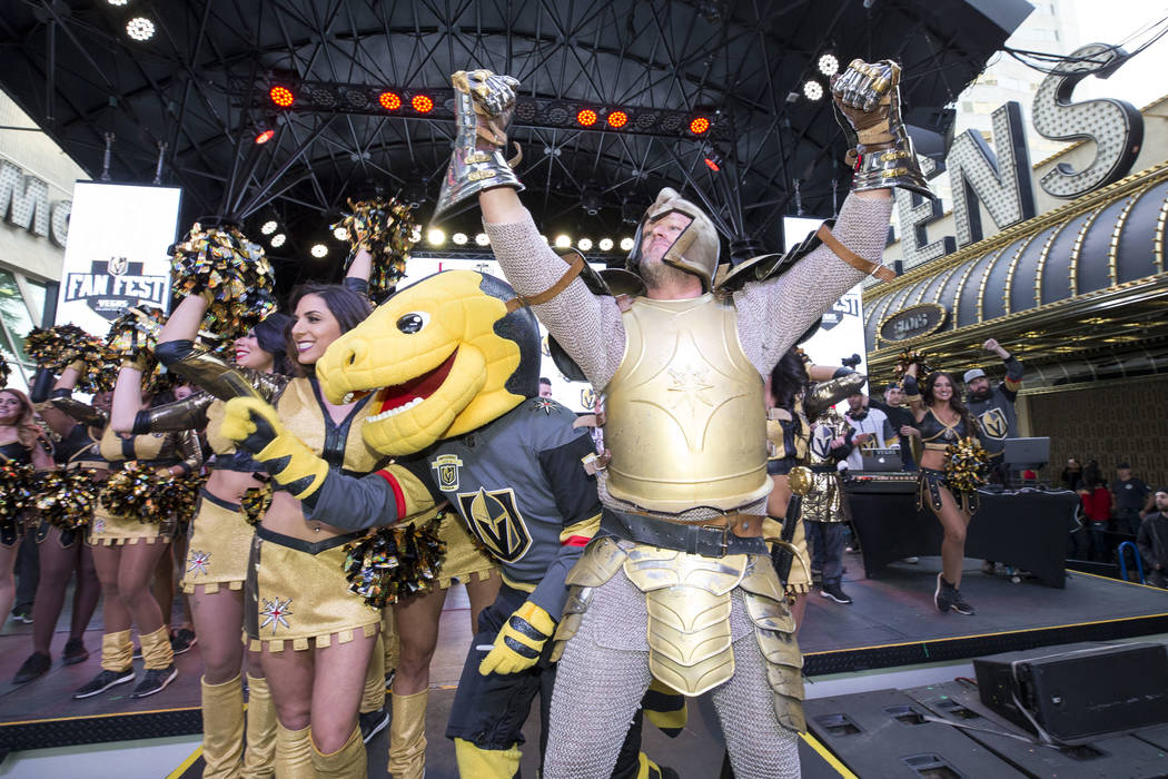 Chance the Golden Gila Monster, left, and the Golden Knight hype the crowd during the team's first fan fest at the Fremont Street Experience in downtown Las Vegas on Sunday, Jan. 14, 2018. Richard ...