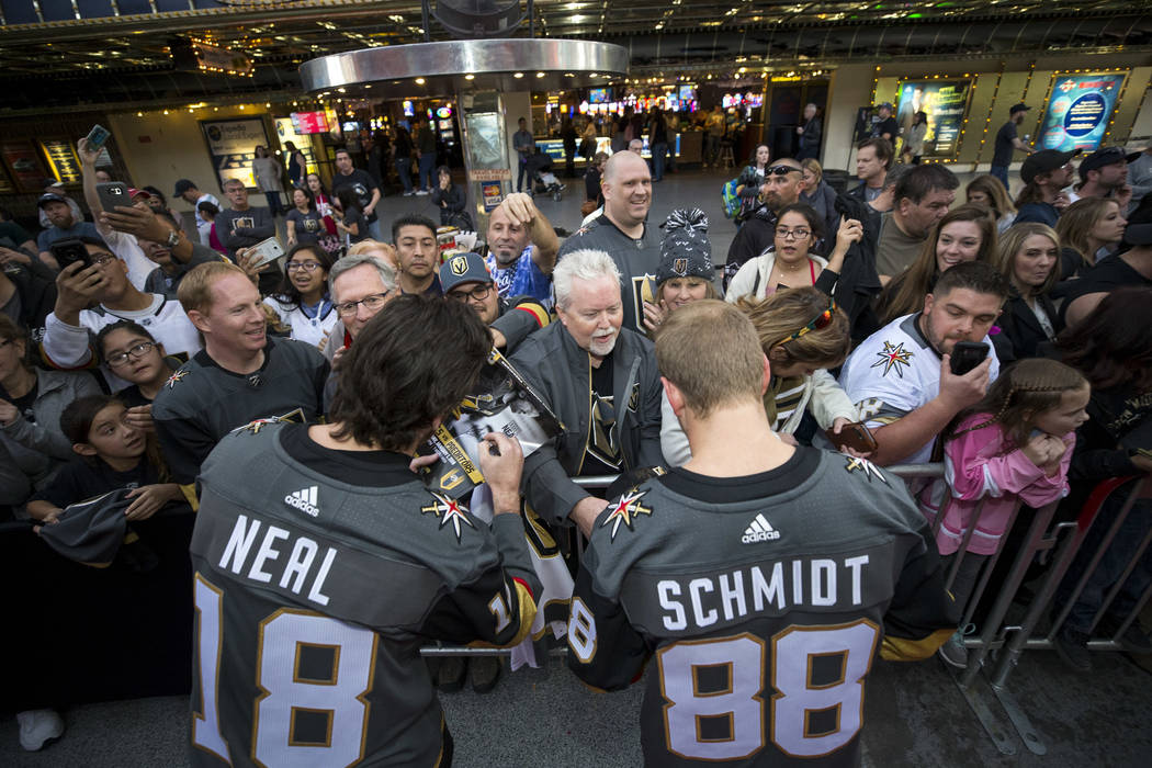 Vegas Golden Knights left wing James Neal (18) and defenseman Nate Schmidt (88) sign autographs during the team's first fan fest at the Fremont Street Experience in downtown Las Vegas on Sunday, J ...
