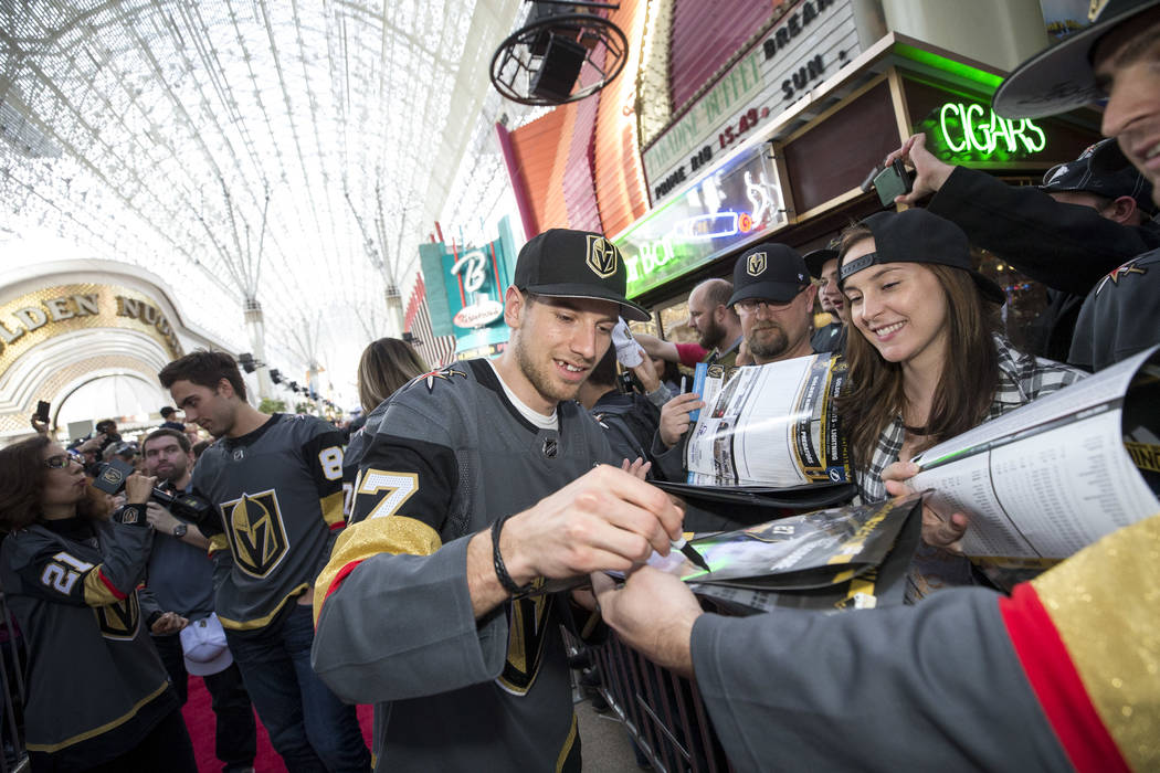 Vegas Golden Knights defenseman Shea Theodore (27) signs autographs during the team's first fan fest at the Fremont Street Experience in downtown Las Vegas on Sunday, Jan. 14, 2018. Richard Brian ...