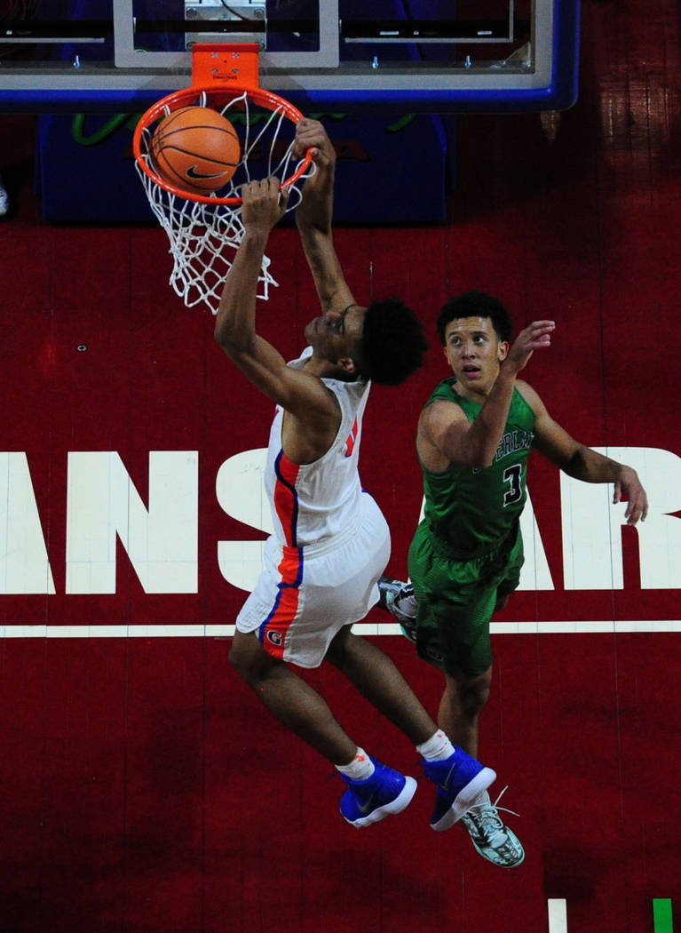 Bishop Gorman center Isaiah Cottrell dunks in front of Overland (Colo.) guard Tuscson Redding (3) during their prep basketball game at Orleans Arena in Las Vegas Wednesday, Dec. 20, 2017. Josh Hol ...