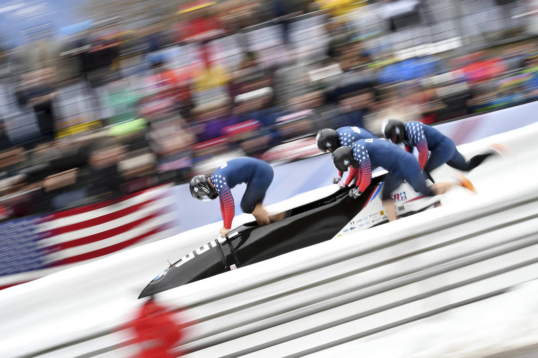 Justin Olsen, left, and his teammates  Austin Landis, Evan Weinstock and Samuel Michener from the United States start their first run of the four-man bob race at the bob World Cup in Igls, near In ...