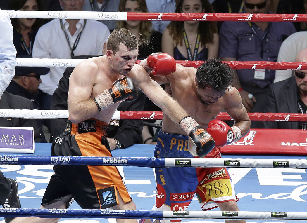 Jeff Horn of Australia, left, lands a left to  Manny Pacquiao of the Philippines, right, during their WBO World Welterweight title fight in Brisbane, Australia, Sunday, July 2, 2017.  Pacquiao los ...