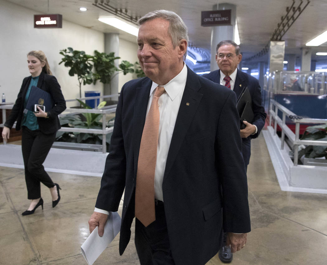 Sen. Dick Durbin, D-Ill., followed by Sen. Bob Menendez, D-N.J., walks to the Senate as Congress moves closer to the funding deadline to avoid a government shutdown, at the Capitol in Washington, ...
