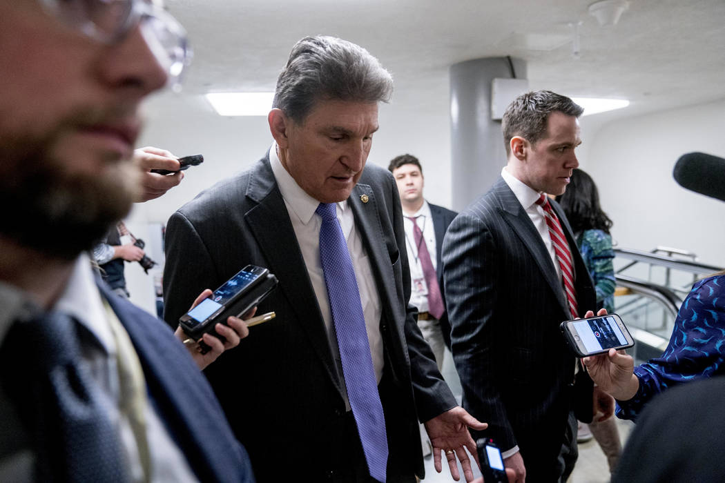 Sen. Joe Manchin, D-W.Va., speaks to reporters as he walks towards the Senate as Congress moves closer to the funding deadline to avoid a government shutdown on Capitol Hill in Washington, Thursda ...