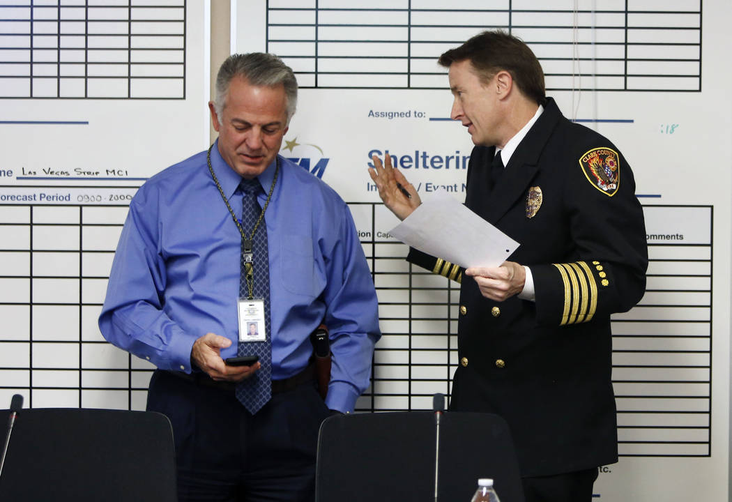 Clark County Sheriff Joe Lombardo, left, and Deputy Fire Chief John Steinbeck chat prior to the start of the Nevada Homeland Security Commission meeting on Monday, Jan. 29, 2018, in Las Vegas. (Bi ...