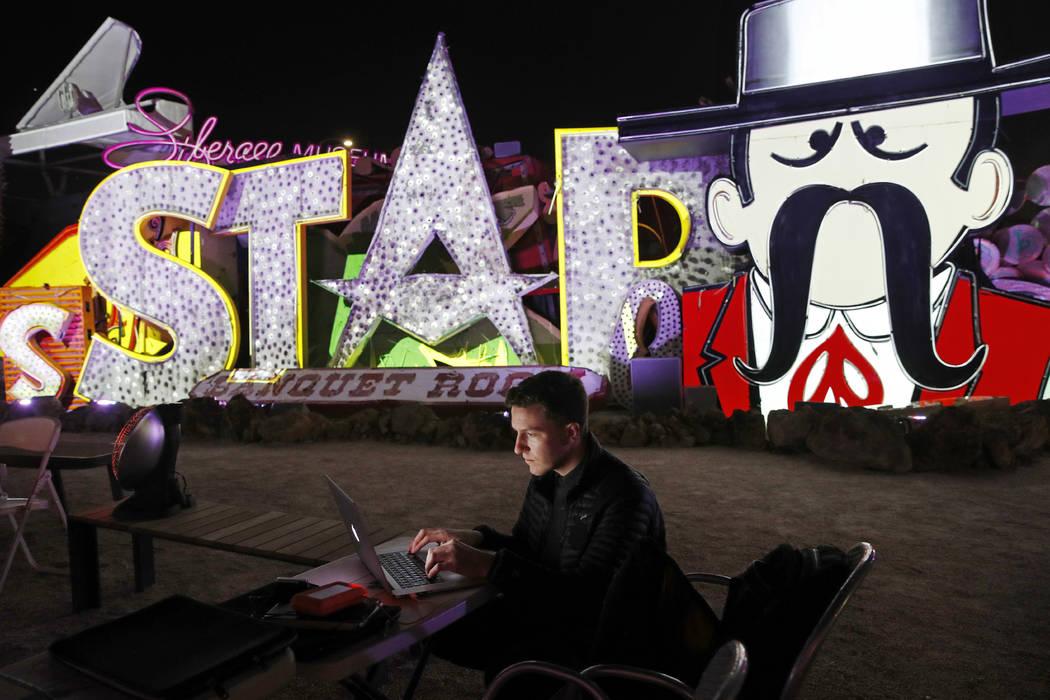 In this Jan. 24, 2018, photo, digital artist and designer Craig Winslow works on an exhibit at the Neon Museum in Las Vegas. Starting this week, visitors will be able to see many of the city's cla ...