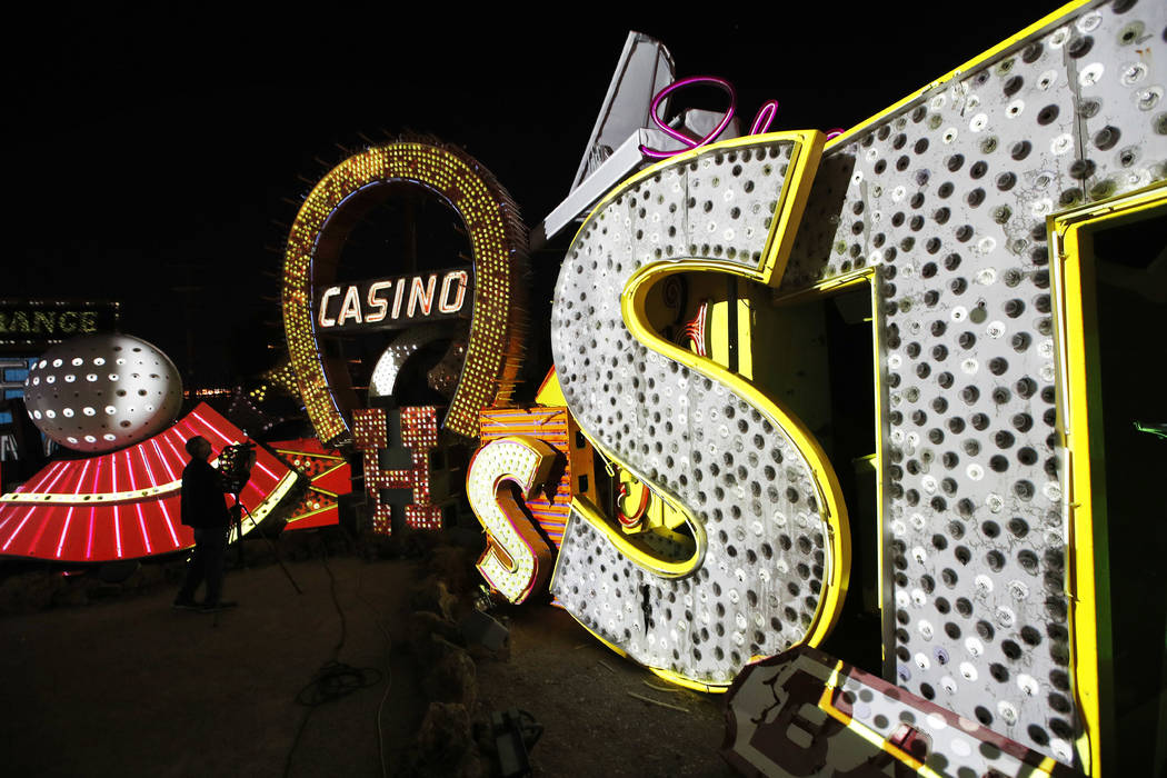 In this Jan. 24, 2018, photo a videographer shoots video of an exhibit at the Neon Museum in Las Vegas. Starting this week, visitors will be able to see many of the city's classic neon signs just  ...