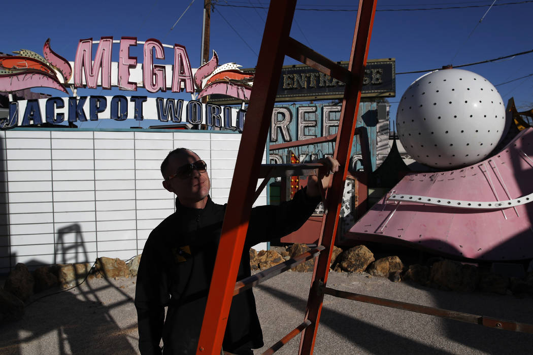 In this Jan. 23, 2018, photo, John Humphries works on an exhibit at the Neon Museum in Las Vegas. Starting this week, visitors will be able to see many of the city's classic neon signs just like t ...