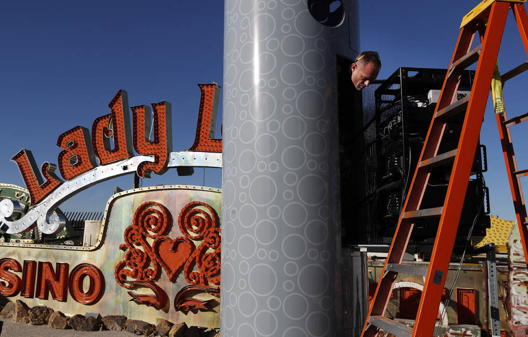 In this Jan. 23, 2018, photo, John Humphries works on an exhibit at the Neon Museum in Las Vegas. Starting this week, visitors will be able to see many of the city's classic neon signs just like t ...