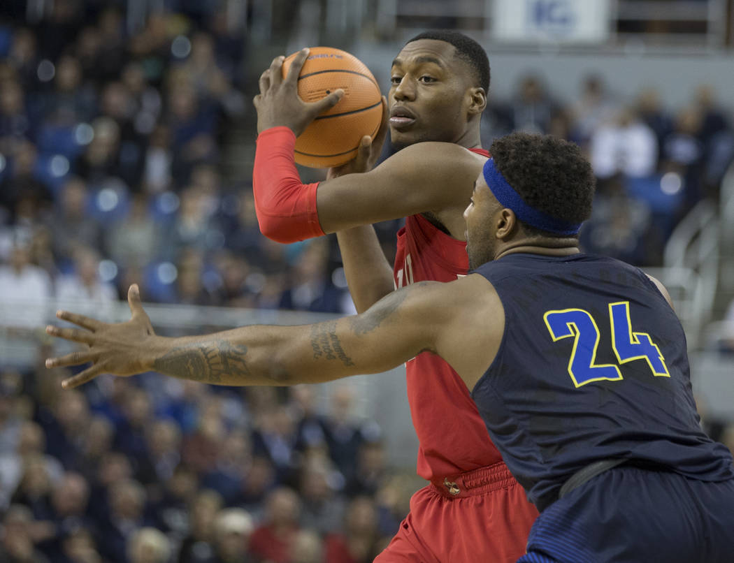 UNLV's Brandon McCoy looks to pass as Nevada's Jordan Caroline defend the second half of an NCAA college basketball game in Reno, Nev., Wednesday, Feb. 7, 2018. (AP Photo/Tom R. Smedes)