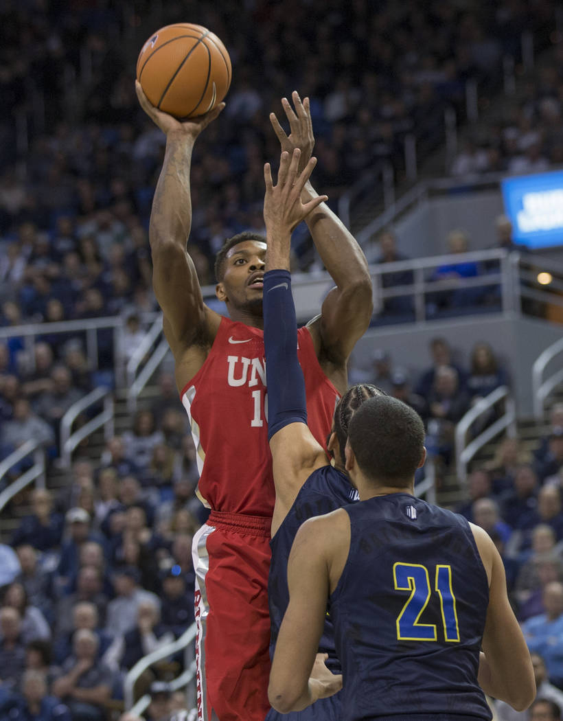 UNLV's Shakur Hardy shoots over Nevada's Cody Martin during the first half of an NCAA college basketball game in Reno, Nev., Wednesday, Feb. 7, 2018. (AP Photo/Tom R. Smedes)