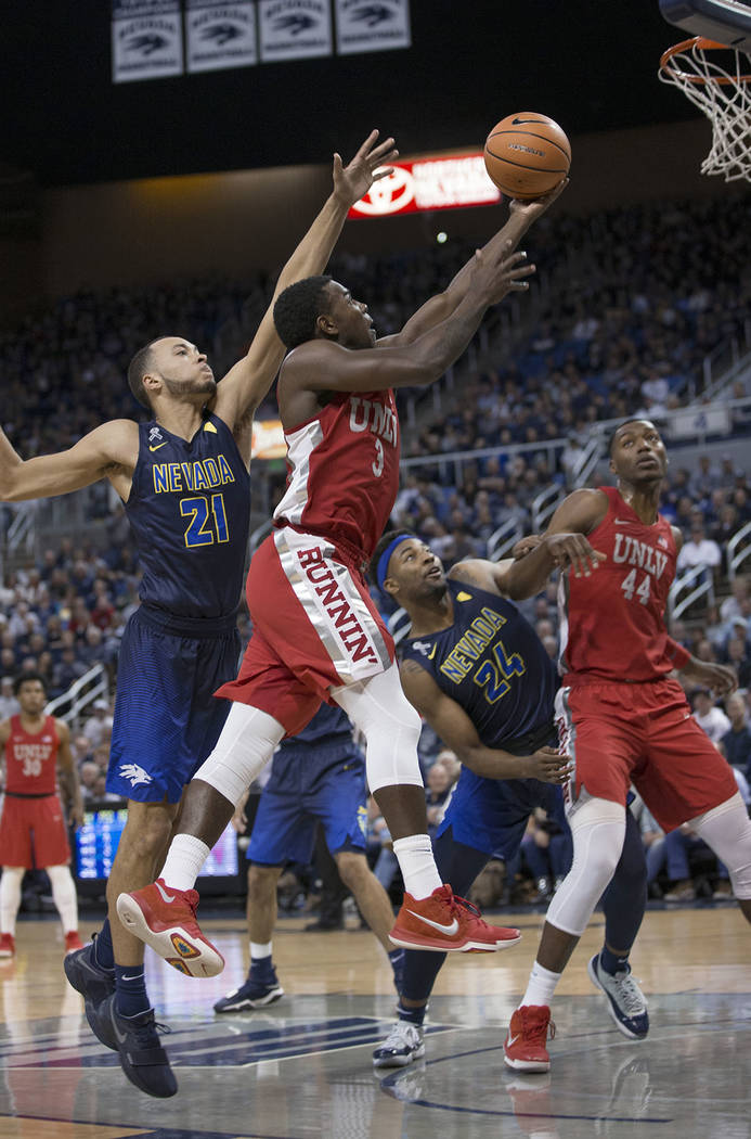 UNLV's Amauri Hardy shoots as Nevada's Kendall Stephens defends during the first half of an NCAA college basketball game in Reno, Nev., Wednesday, Feb. 7, 2018. (AP Photo/Tom R. Smedes)