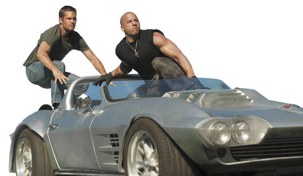 (L to R) Brian O'Conner (PAUL WALKER) and Dom Toretto (VIN DIESEL) in a reunion of returning all-stars from every chapter of the explosive franchise built on speed--&quot;Fast Five&quot;.