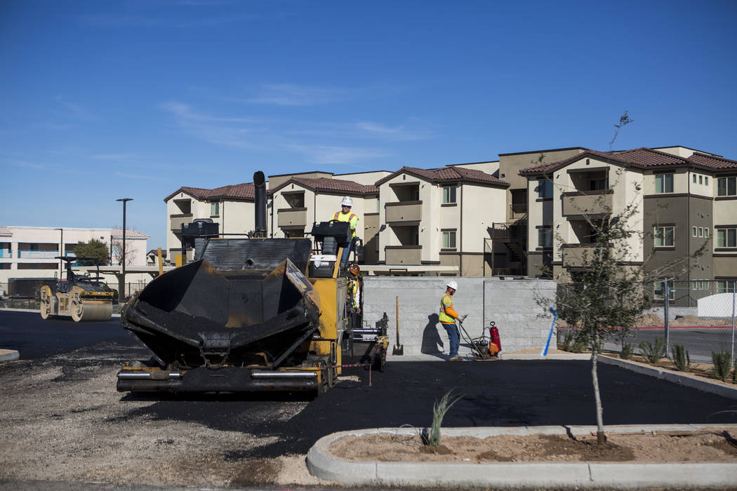 Construction workers finish paving a parking lot at the Boulder Pines Family Apartments on Boulder Highway in Las Vegas on Friday, Feb. 2, 2018.  Patrick Connolly Las Vegas Review-Journal @PConnPie