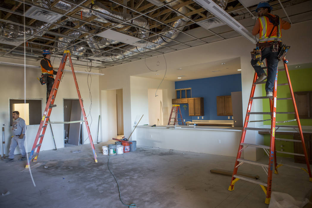 Construction workers run wiring in the space that will become the leasing office and recreation building at Boulder Pines Family Apartments on Boulder Highway in Las Vegas on Friday, Feb. 2, 2018. ...