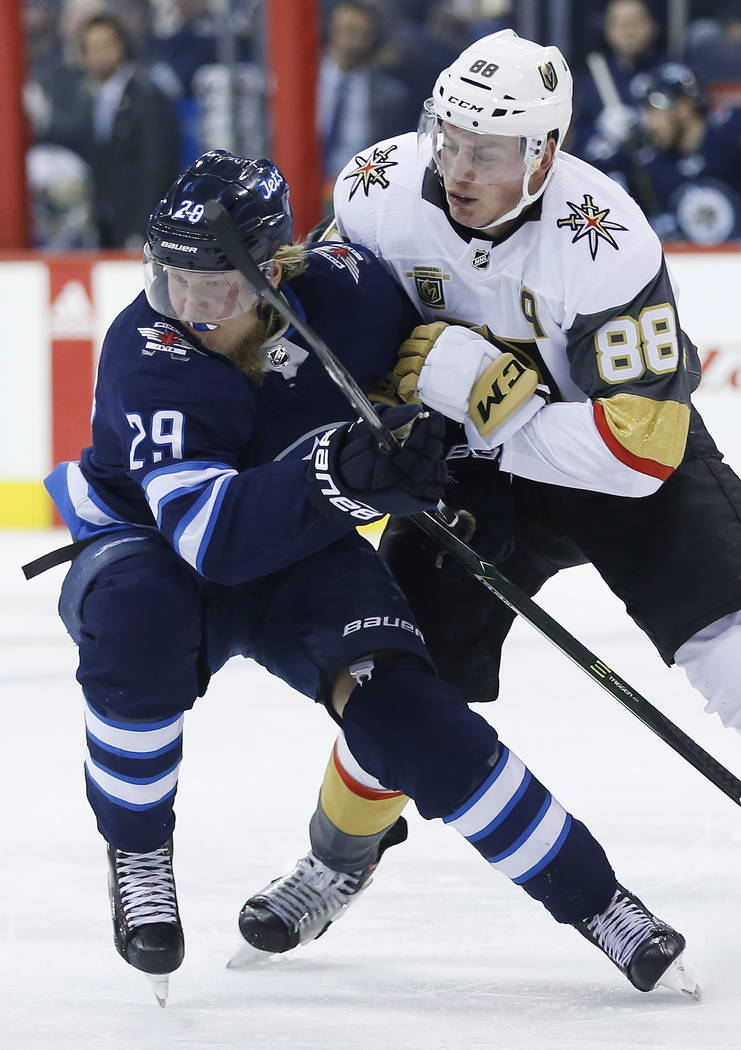 Vegas Golden Knights' Nate Schmidt (88) and Winnipeg Jets' Patrik Laine (29) collide during the second period of an NHL hockey game Thursday, Feb. 1, 2018, in Winnipeg, Manitoba. (John Woods/The C ...