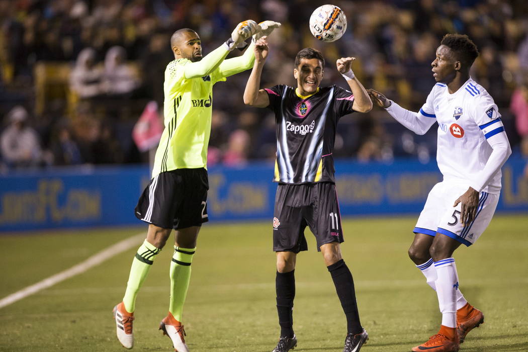 Las Vegas Lights FC Marcelo Oscar Hernandez (11) goes for the ball against Montreal Impact’s Cle´ment Diop (23) and Zakaria Diallo (5) during the exhibition match at Cashman Field in L ...