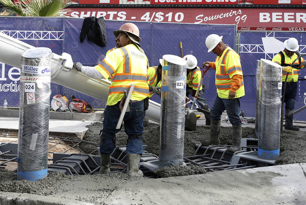 Construction crews pour cement where they began installing steel posts on the Strip near Aria hotel-casino Monday, Nov. 13, 2017 to protect pedestrians, locals and tourists walking along Las Vegas ...