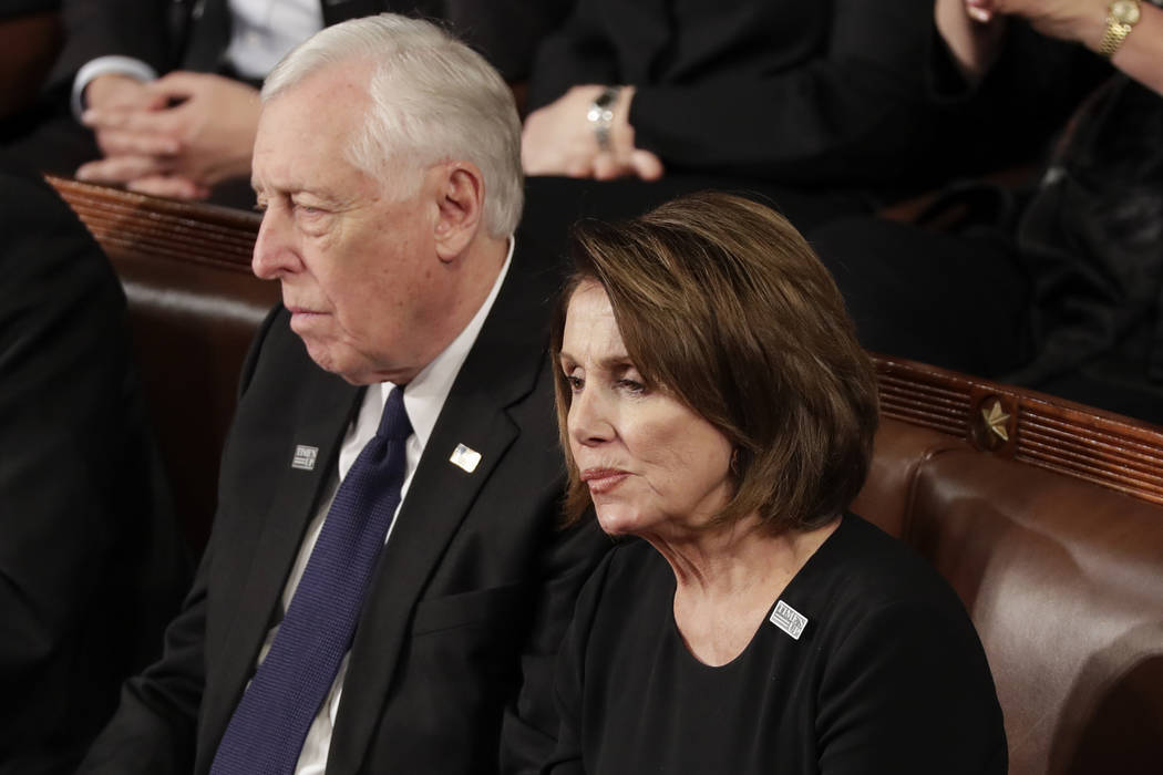 House Minority Leader Nancy Pelosi of California and Minority Whip Steny Hoyer, D-Md., listen to the State of the Union address to a joint session of Congress on Capitol Hill in Washington, Tuesda ...