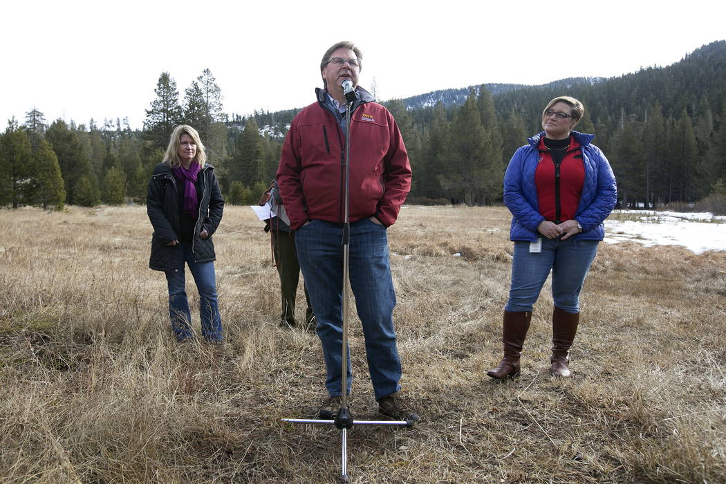 Grant Davis, director of the Dept. of Water Resources, center, discusses the results of the first snow survey of the season at the nearly snow barren Phillips Station snow course, near Echo Summit ...