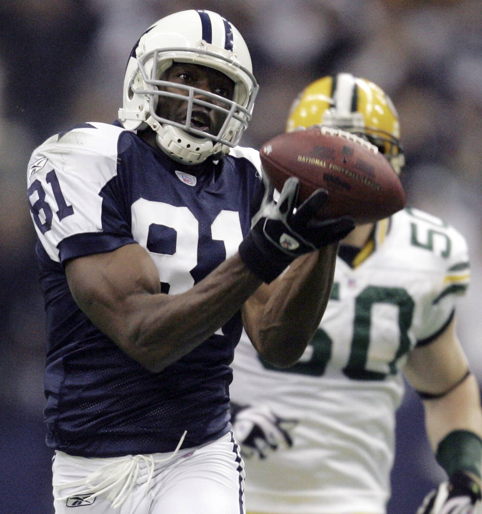 FILE - In this Nov. 29, 2007, file photo, Dallas Cowboys wide receiver Terrell Owens (81) pulls in a 48-yard pass as Green Bay Packers linebacker A.J. Hawk (50) defends in the second quarter in th ...