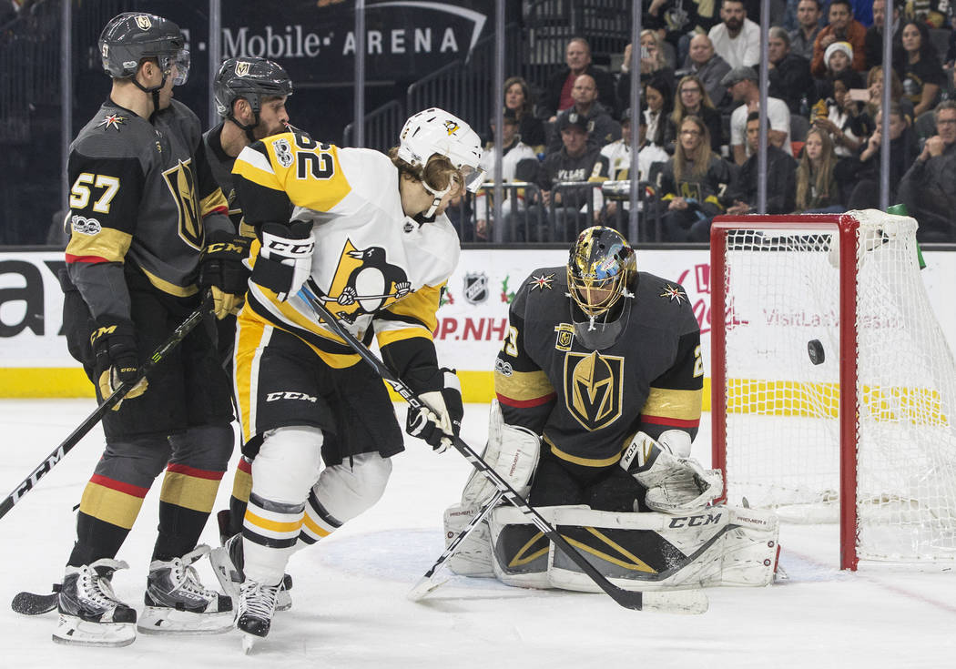 Golden Knights goaltender Marc-Andre Fleury (29) makes a save against Penguins left wing Carl Hagelin  (62) during the second period of Vegas' home matchup with Pittsburgh on Thursday, Dec. 14, 20 ...