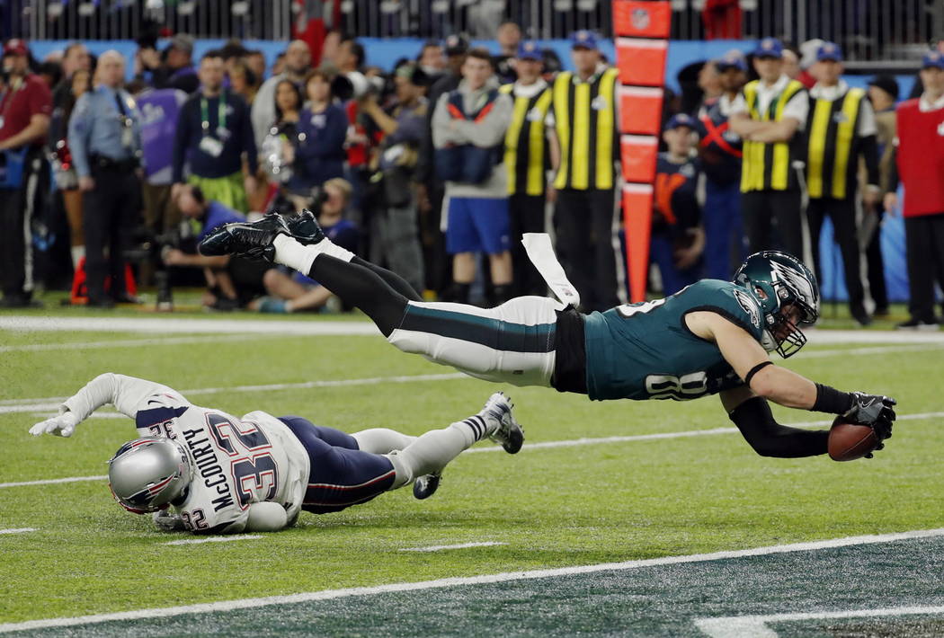 Philadelphia Eagles tight end Zach Ertz (86) dives into the end zone over New England Patriots free safety Devin McCourty (32) for a touchdown, during the second half of the NFL Super Bowl 52 foot ...
