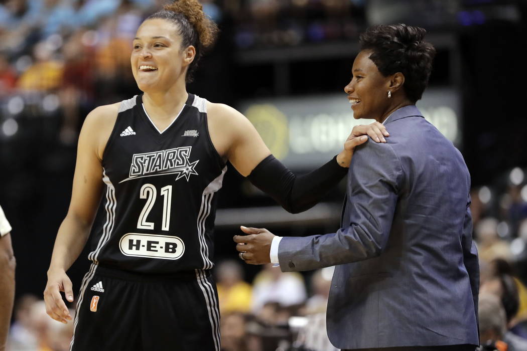 San Antonio Stars' Kayla McBride laughs with head coach Vickie Johnson during the second half of a WNBA basketball game against the Indiana Fever in Indianapolis in July. (AP Photo/Darron Cummings ...