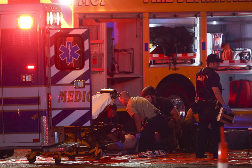 A wounded person is tended to as Las Vegas police respond during an