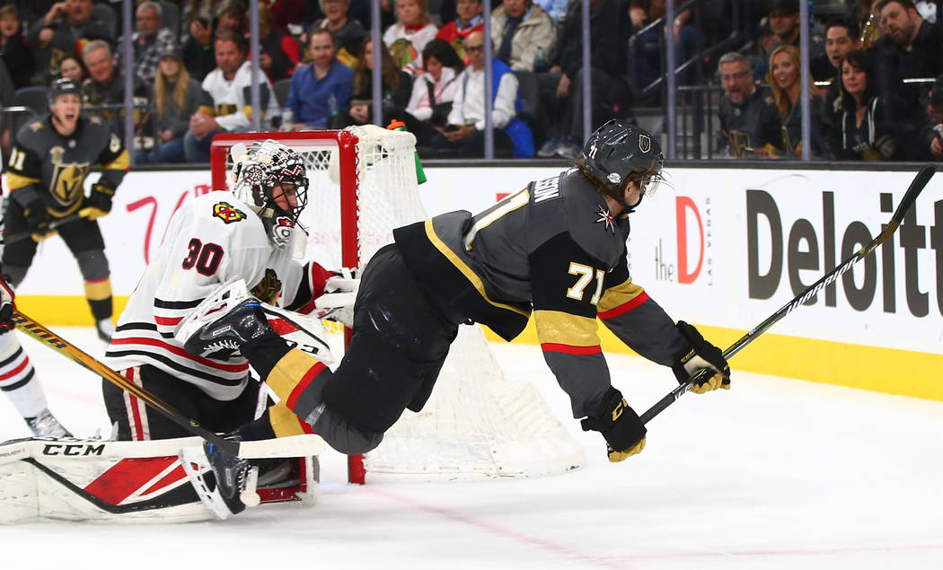 Golden Knights center William Karlsson (71) gets tripped up over Chicago Blackhawks goaltender Jeff Glass (30) during an NHL game at T-Mobile Arena in Las Vegas on Tuesday, Feb. 13, 2018. Chase St ...