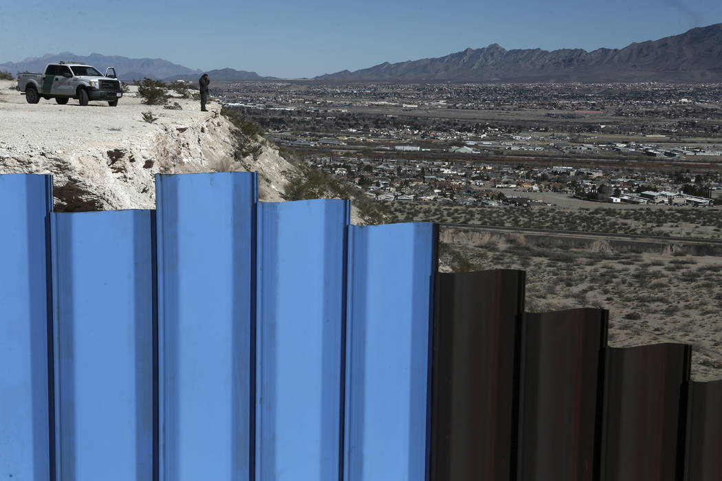 In this Jan. 25, 2017, file photo, an agent of the border patrol, observes near the Mexico-US border fence, on the Mexican side, separating the towns of Anapra, Mexico and Sunland Park, N.M. (AP ...