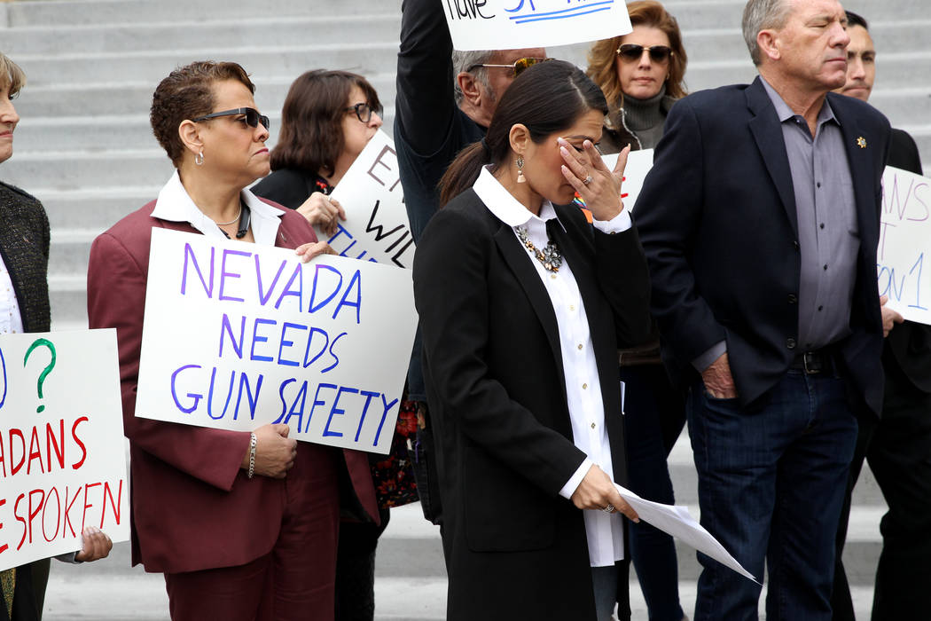 Sandra Jauregui, a Nevada assemblywoman and Route 91 Harvest festival survivor, wipes tears after speaking with supporters of Question 1 outside the Regional Justice Center in Las Vegas on Friday, ...