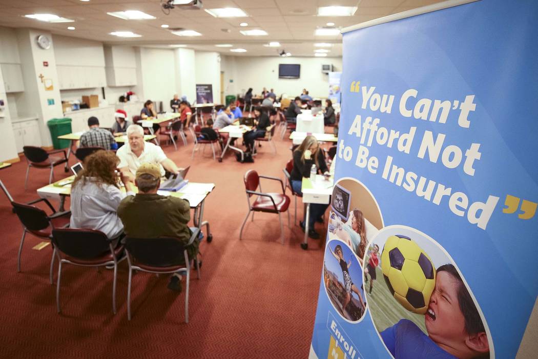 People sign up for the exchange during an open enrollment event for the Nevada Health Link at St. Rose Dominican Hospital San Martin Campus, Friday, Dec. 14, 2017, in Las Vegas. (Richard Brian/Las ...