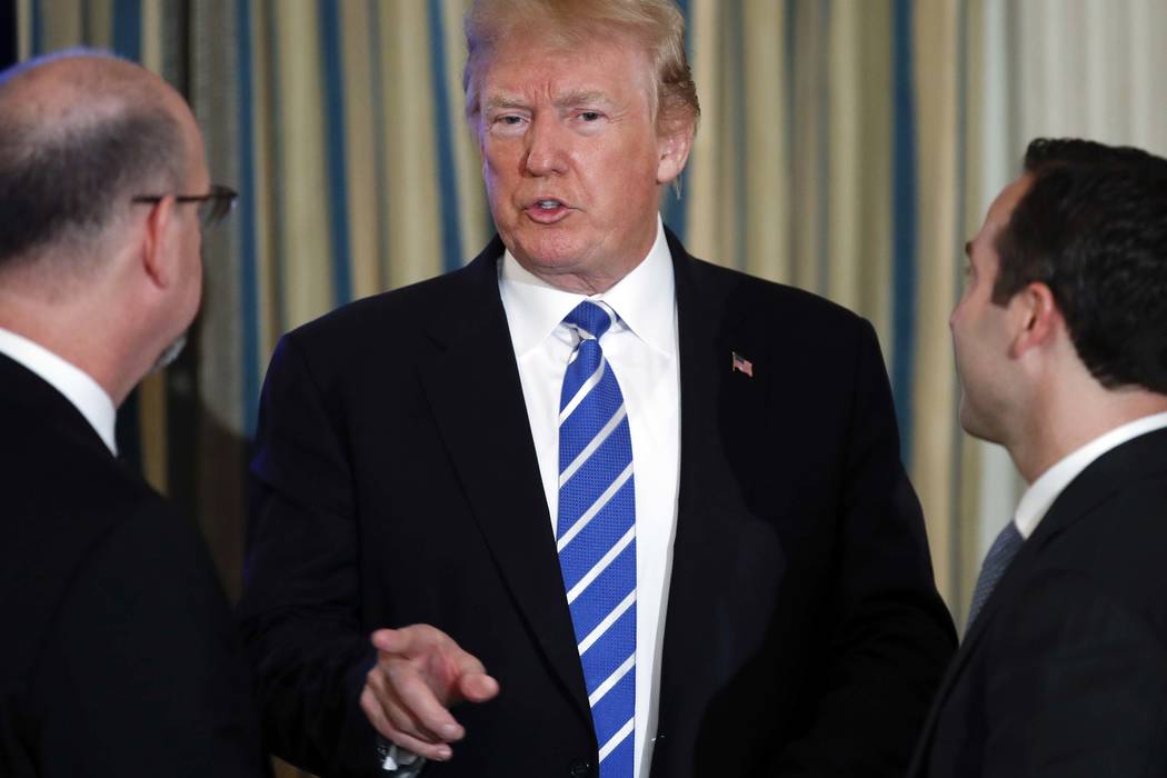 President Donald Trump pauses to speak to guests as he leaves the State Dining Room of the White House in Washington, Monday, Feb. 12, 2018, after a meeting with state and local officials about in ...