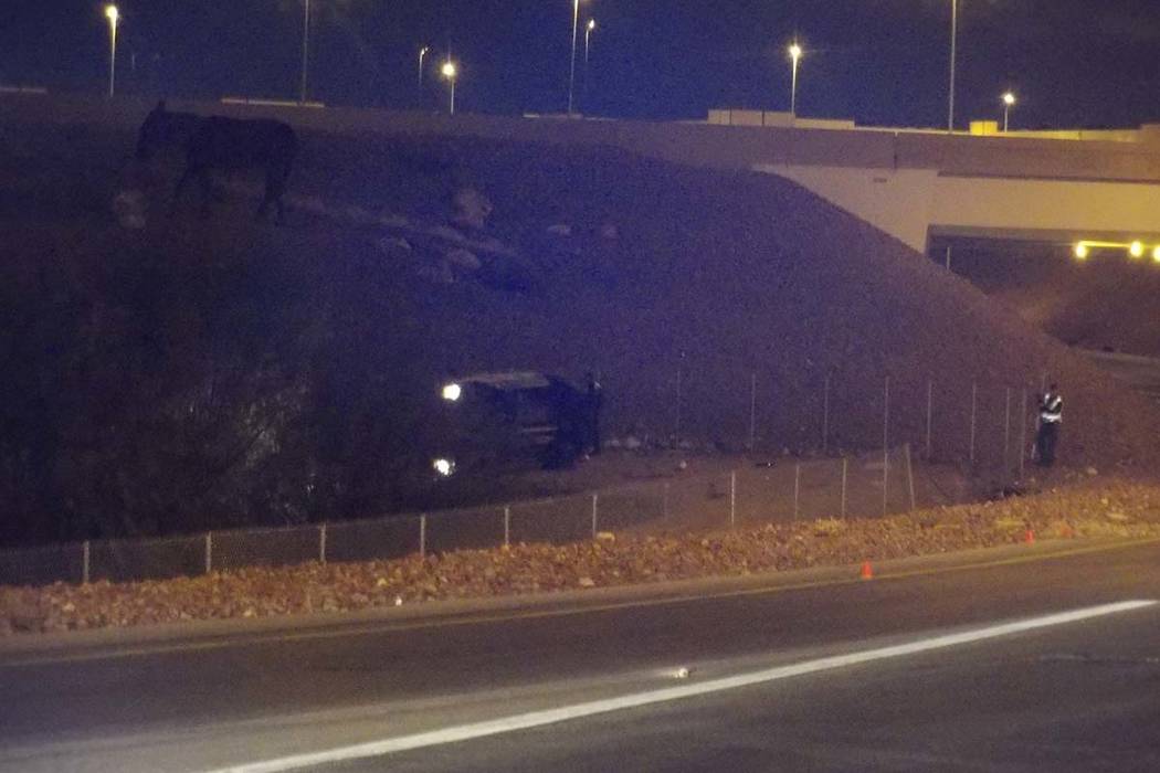 An AMR ambulance transporting a patient rolled over on the ramp leading from northbound I-15 to the westbound 215 Beltway Tuesday morning killing a first responder and the patient. (Max Michor/Las ...
