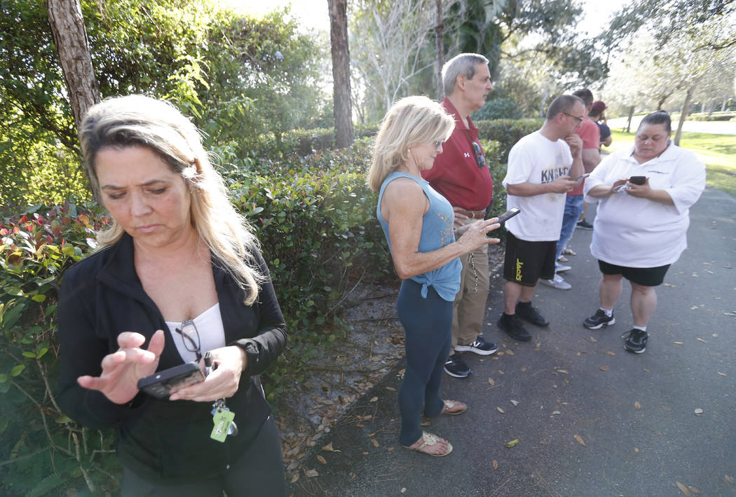 Anxious family members wait for information on students, Wednesday, Feb. 14, 2018, in Parkland, Fla. A shooting at Marjory Stoneman Douglas High School sent students rushing into the streets as SW ...
