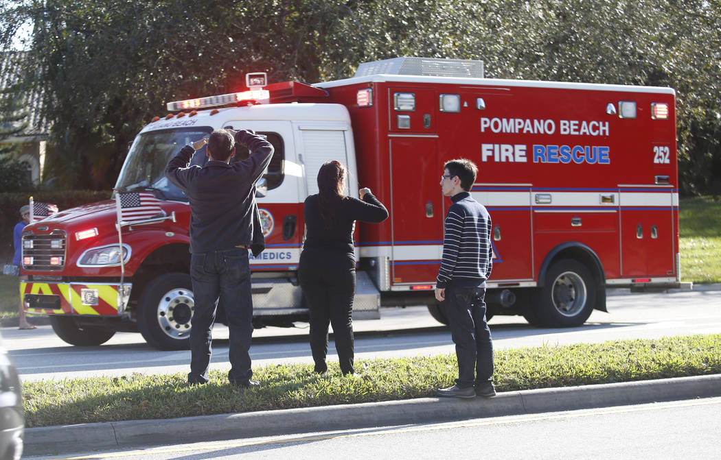 Anxious family members watch a rescue vehicle pass by, Wednesday, Feb. 14, 2018, in Parkland, Fla. A shooting at Marjory Stoneman Douglas High School school sent students rushing into the streets  ...