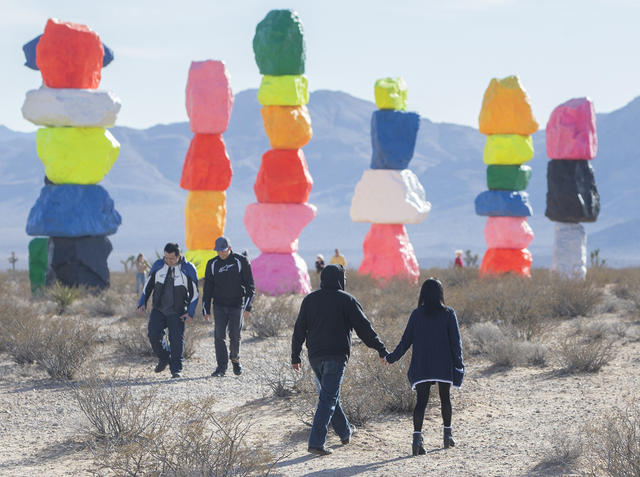Lexus Estabillo, left, holds hands with Kayla Perez as they walk towards the Seven Magic Mountains art project  on Monday, Jan. 30, 2017, near Jean Dry Lake, Nev. (Benjamin Hager/Las Vegas Review- ...
