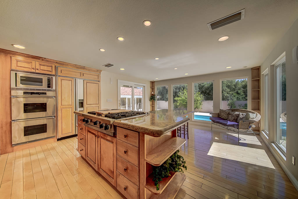 The kitchen has double ovens, custom wood cabinetry and granite countertop. (Nevada Realty Connection)