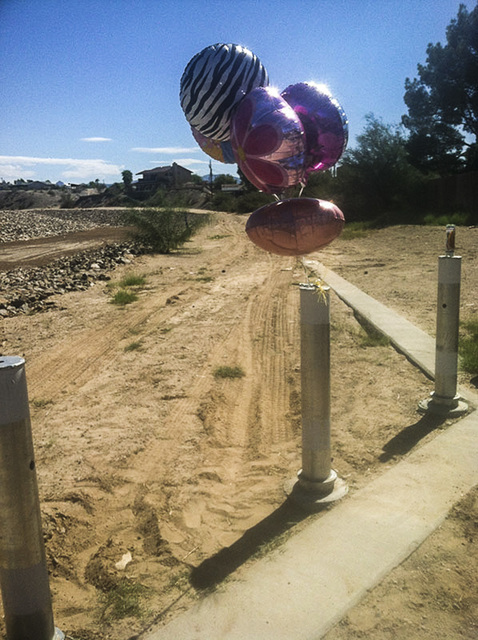 Balloons were left near the lot at Chaparral and Country Club drives in Bullhead City, Arizona, where the body of 8-year-old Isabella Grogan-Cannella was found in September 2014. (Annalise Little/ ...