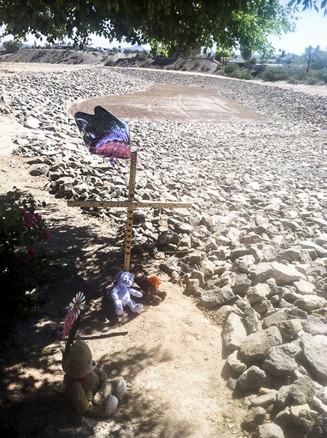Balloons and stuffed toys are near the lot at Chaparral and Country Club drives in Bullhead City, Arizona, where the body of 8-year-old Isabella Grogan-Cannella was found in September 2014. (Annal ...