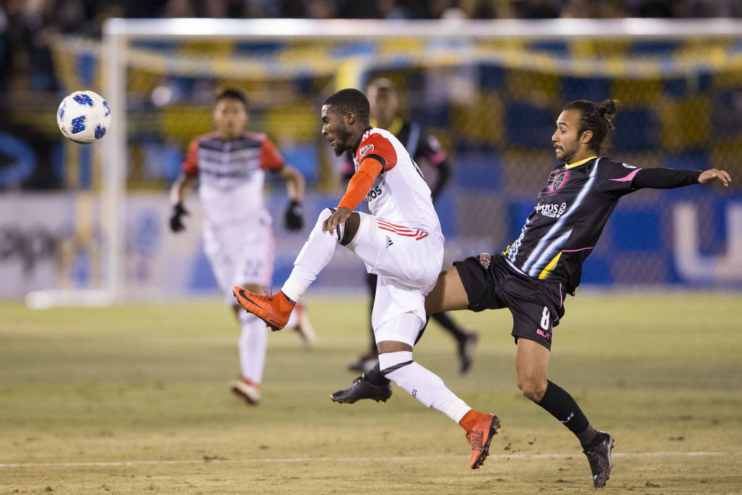 D.C. United's Oniel Fisher (91) and Las Vegas Lights FC’s Isaac Diaz (8) go for the ball during the first half of the exhibition soccer game at Cashman Field in Las Vegas, Saturday, Feb. 24 ...