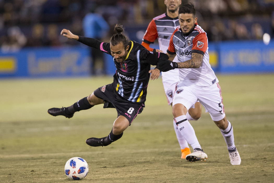 Las Vegas Lights FC’s Isaac Diaz (8) is fouled by D.C. United's Junior Moreno (5) fight for the ball during the first half of the exhibition soccer game at Cashman Field in Las Vegas, Satur ...