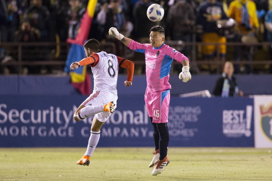 Las Vegas Lights FC's Angel Alvarez (45) clears the ball against D.C. United's Ulises Segura (8) during the first half of the exhibition soccer game at Cashman Field in Las Vegas, Saturday, Feb. 2 ...