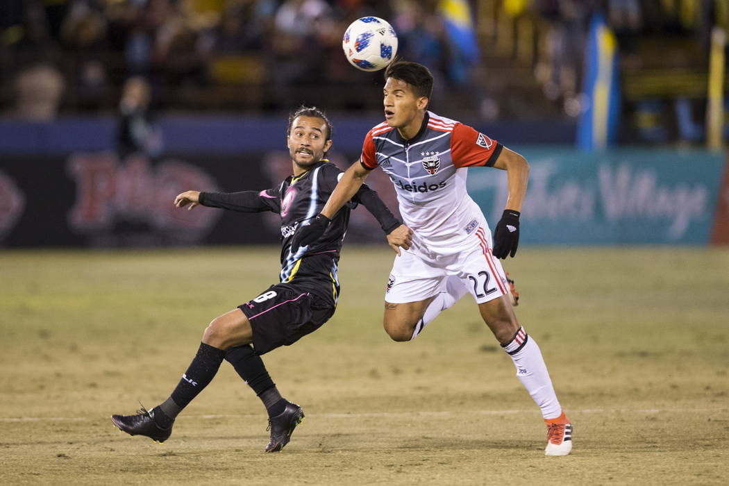 Las Vegas Lights FC’s Isaac Diaz (8) and D.C. United Yamil Asad (22) go for the ball during the first half of the exhibition soccer game at Cashman Field in Las Vegas, Saturday, Feb. 24, 20 ...