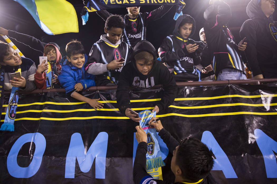 Las Vegas Lights FC’s Marcelo Alatorre (16) signs autographs after the exhibition soccer game against D.C. United at Cashman Field in Las Vegas, Saturday, Feb. 24, 2018. The Lights FC lost  ...